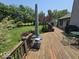 Enjoy a spacious wooden deck overlooking a lush backyard with mature trees and outdoor seating at 8144 Grassy Meadow Cir, Indianapolis, IN 46259