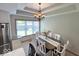 Bright dining area with chandelier lighting and a large window view at 8144 Grassy Meadow Cir, Indianapolis, IN 46259