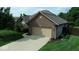 Well-maintained brick house with a two car garage and mature landscaping at 8144 Grassy Meadow Cir, Indianapolis, IN 46259