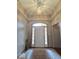 Inviting foyer with decorative light fixture, sidelights, and neutral walls at 8144 Grassy Meadow Cir, Indianapolis, IN 46259