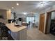 Open kitchen and dining area with an island, stainless appliances, and tile floors at 8144 Grassy Meadow Cir, Indianapolis, IN 46259