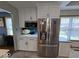 Modern stainless-steel refrigerator and microwave with white cabinets at 8144 Grassy Meadow Cir, Indianapolis, IN 46259