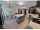 Open kitchen and dining area with an island, stainless appliances, and tile floors at 8144 Grassy Meadow Cir, Indianapolis, IN 46259