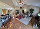 Bright living room with hardwood floors, vaulted ceiling, and large sectional sofa at 8144 Grassy Meadow Cir, Indianapolis, IN 46259