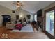 Inviting living room featuring a fireplace, vaulted ceilings, hardwood flooring, and a cozy sectional couch at 8144 Grassy Meadow Cir, Indianapolis, IN 46259
