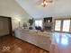 Spacious living room boasts hardwood floors, fireplace, neutral colors, and a large sectional couch at 8144 Grassy Meadow Cir, Indianapolis, IN 46259