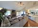 Bright living room features hardwood floors, a brick fireplace, and seamless flow into the kitchen at 8144 Grassy Meadow Cir, Indianapolis, IN 46259