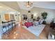 Warm living room flowing into a well-equipped kitchen; featuring hardwood floors, and neutral colors at 8144 Grassy Meadow Cir, Indianapolis, IN 46259