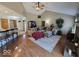 Open-concept living room featuring hardwood floors, vaulted ceiling, and ample seating at 8144 Grassy Meadow Cir, Indianapolis, IN 46259