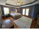 Spacious main bedroom features tray ceilings, wood floors, and a private entrance at 8144 Grassy Meadow Cir, Indianapolis, IN 46259