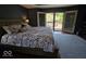 Comfortable main bedroom with access to a private deck with a hot tub at 8144 Grassy Meadow Cir, Indianapolis, IN 46259