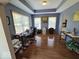 Well-lit home office featuring a tray ceiling, hardwood floors, and large windows with pleasant views at 8144 Grassy Meadow Cir, Indianapolis, IN 46259