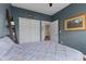 Comfortable bedroom with blue walls, closet space, and a view to the ensuite bathroom at 820 Elise Dr, Westfield, IN 46074