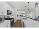Modern kitchen features white cabinets, stainless steel appliances, and island with bar seating at 820 Elise Dr, Westfield, IN 46074