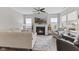 Cozy living room with fireplace, comfortable seating, and modern ceiling fan at 820 Elise Dr, Westfield, IN 46074