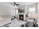 Bright living room featuring a fireplace, a ceiling fan, and lots of natural light at 820 Elise Dr, Westfield, IN 46074