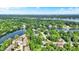 Aerial view of neighborhood, community with mature trees, winding canals and lush green spaces at 8261 Twin Pointe Cir, Indianapolis, IN 46236