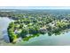 Stunning aerial view of waterfront homes and docks nestled along a tranquil lake and lush trees at 8261 Twin Pointe Cir, Indianapolis, IN 46236