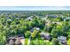 Lush, leafy neighborhood, with green trees shading lovely residences, community lake, and a beautiful blue sky at 8261 Twin Pointe Cir, Indianapolis, IN 46236
