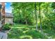Lush backyard featuring a private wooded area with a grassy lawn and mature trees at 8261 Twin Pointe Cir, Indianapolis, IN 46236