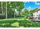 The spacious backyard features a stone patio with lounge furniture, a grill, and a large grassy area at 8261 Twin Pointe Cir, Indianapolis, IN 46236