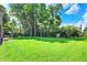 Lush green backyard featuring a spacious lawn, mature trees, and outdoor seating area at 8261 Twin Pointe Cir, Indianapolis, IN 46236