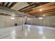An unfinished basement with lighting offers space for storage at 8261 Twin Pointe Cir, Indianapolis, IN 46236