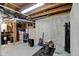Basement area showcasing gym equipment and storage containers at 8261 Twin Pointe Cir, Indianapolis, IN 46236