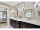 Double vanity bathroom with dark cabinetry, marble countertop, and decorative mirrors, offering style and functionality at 8261 Twin Pointe Cir, Indianapolis, IN 46236
