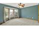 A cozy bedroom with blue walls, a ceiling fan, and a bright bay window at 8261 Twin Pointe Cir, Indianapolis, IN 46236