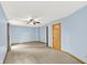 Large bedroom with carpet and light blue walls with 2 doors at 8261 Twin Pointe Cir, Indianapolis, IN 46236