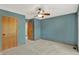 The bedroom has a ceiling fan, blue walls, and wood trim at 8261 Twin Pointe Cir, Indianapolis, IN 46236