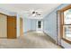 Sunny bedroom featuring blue walls, carpet flooring, and large windows with backyard views at 8261 Twin Pointe Cir, Indianapolis, IN 46236