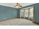 A cozy bedroom boasts blue walls, a ceiling fan, and a bay window at 8261 Twin Pointe Cir, Indianapolis, IN 46236