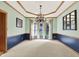 Formal dining room featuring a tray ceiling, chandelier, and large windows at 8261 Twin Pointe Cir, Indianapolis, IN 46236