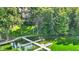 Waterfront estate with private dock and a glimpse of the luxurious home nestled among trees at 8261 Twin Pointe Cir, Indianapolis, IN 46236