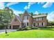 Beautiful two-story brick home featuring an attached garage and well-manicured lawn at 8261 Twin Pointe Cir, Indianapolis, IN 46236