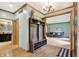 Open foyer leading into a living room with a couch and decor, adjacent to a view of the kitchen at 8261 Twin Pointe Cir, Indianapolis, IN 46236
