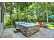 Outdoor hot tub surrounded by mature trees and lounge chairs at 8261 Twin Pointe Cir, Indianapolis, IN 46236
