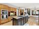 Open kitchen layout showcasing wooden cabinetry, a gas cooktop, and stainless appliances at 8261 Twin Pointe Cir, Indianapolis, IN 46236