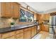 Charming kitchen with wooden cabinets, granite countertops, and stainless steel appliances at 8261 Twin Pointe Cir, Indianapolis, IN 46236