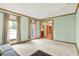 Spacious living room featuring bright walls, two large windows, hardwood trim, and neutral carpet at 8261 Twin Pointe Cir, Indianapolis, IN 46236