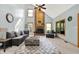 Bright living room featuring a brick fireplace, vaulted ceilings, and large windows for ample natural light at 8261 Twin Pointe Cir, Indianapolis, IN 46236