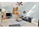 Bright living room featuring high ceilings, a ceiling fan, a staircase, and comfortable seating at 8261 Twin Pointe Cir, Indianapolis, IN 46236