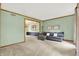 Open-concept living room featuring neutral walls, carpet, and an opening into a dining area at 8261 Twin Pointe Cir, Indianapolis, IN 46236