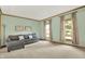 Bright living room with large windows, neutral decor, hardwood trim, and comfortable seating at 8261 Twin Pointe Cir, Indianapolis, IN 46236