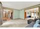 Bright, open living area featuring hardwood trim, neutral carpet, and an entrance to the staircase at 8261 Twin Pointe Cir, Indianapolis, IN 46236