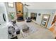 Spacious living room with brick fireplace, high ceilings, large windows, and comfortable seating area at 8261 Twin Pointe Cir, Indianapolis, IN 46236