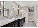Modern main bathroom with dual vanities, marble countertops, and decorative mirrors at 8261 Twin Pointe Cir, Indianapolis, IN 46236