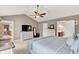 Main bedroom with neutral walls, vaulted ceilings, white furniture, and an open doorway to the bathroom at 8261 Twin Pointe Cir, Indianapolis, IN 46236